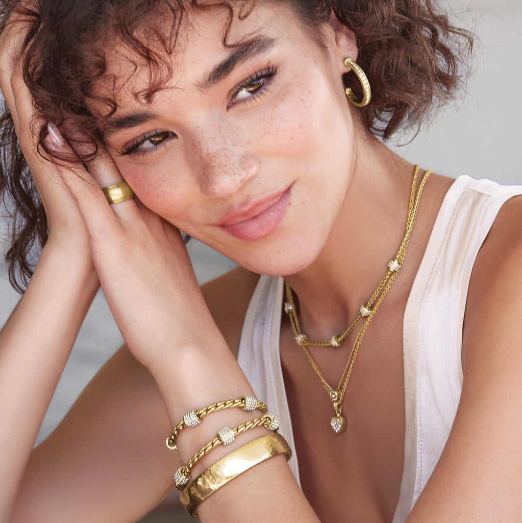 Model wearing Brighton gold Meridian Zenith medium hoop earrings