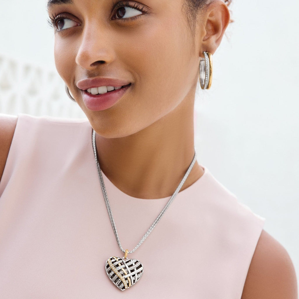 Model is wearing Brighton Neptune's Rings convertible reversible heart necklace