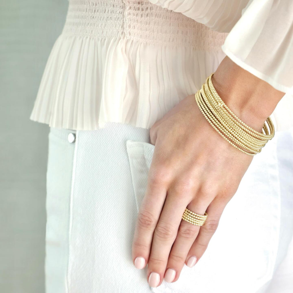 Model is wearing eNewton Design classic gold 2mm bead bracelet