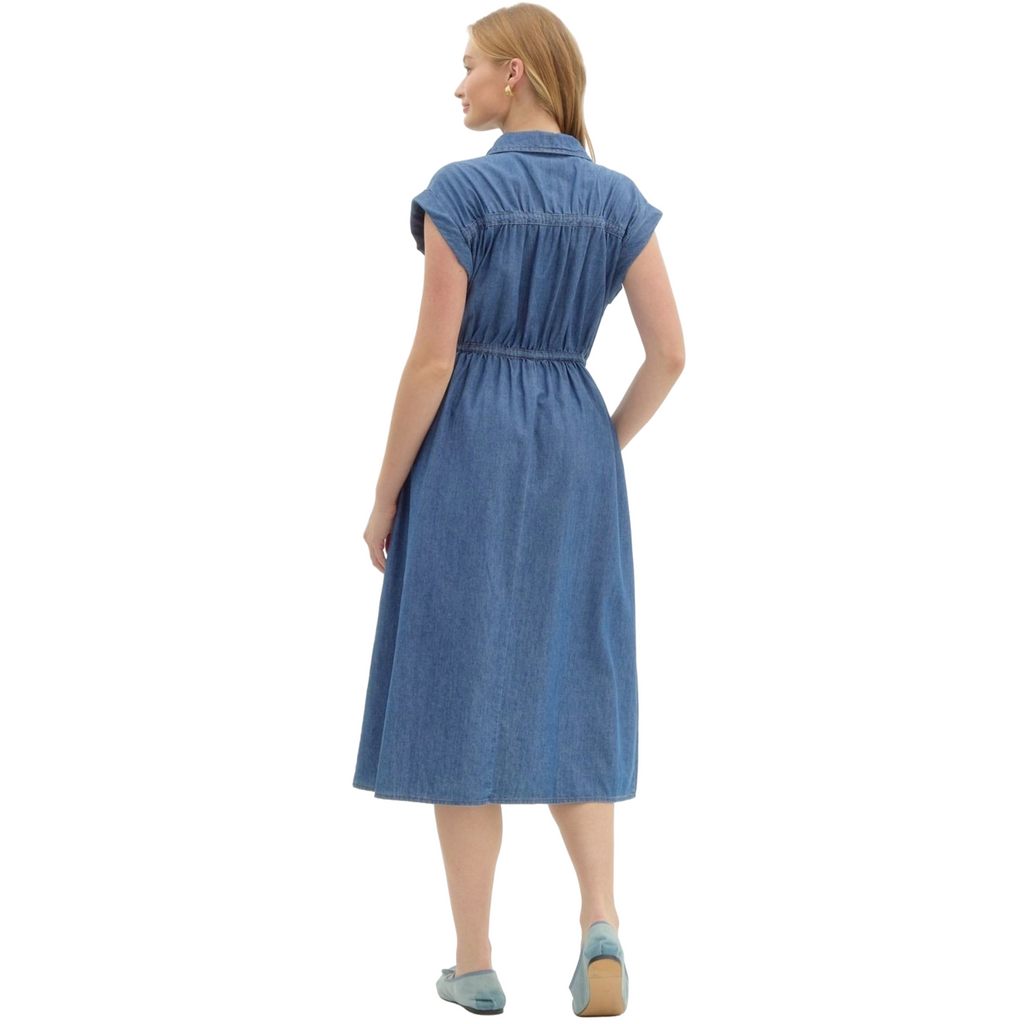 A woman is wearing a knee-length, short-sleeved denim dress with a collar, a full-length zipper down the front, and a drawstring waist.